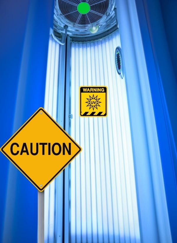 UV warning sign inside a tanning bed highlighting the risks of sunbed use.