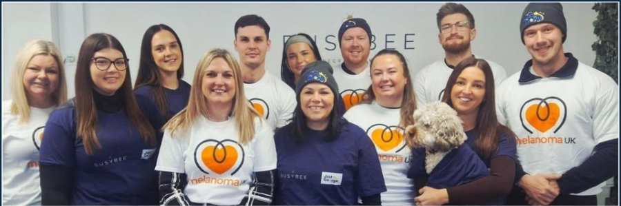 Protective team wearing Melanoma UK t-shirts and hats, raising awareness for skin cancer prevention.