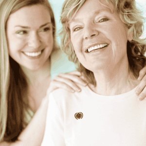 Supportive caregiver and patient smiling together, promoting melanoma awareness and emotional suppor.