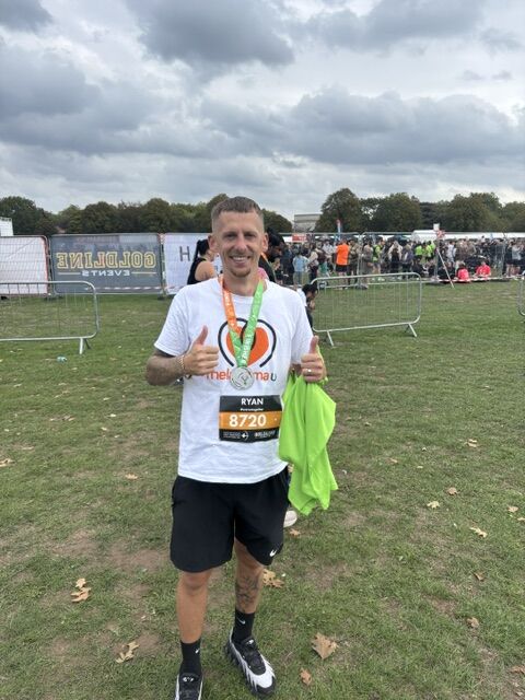 Runner Ryan at Robin Hood Half Marathon with medal and green towel.