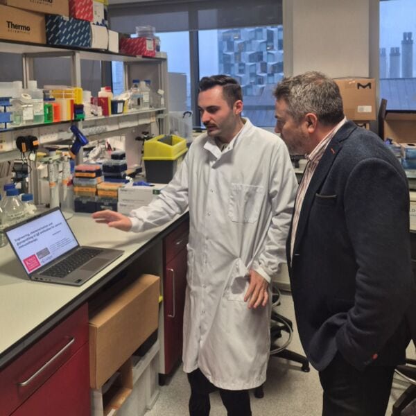 Researchers discussing melanoma research at Kings College London laboratory.